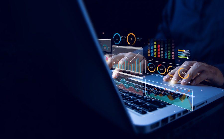 A person analyzing data dashboards and charts on a laptop.